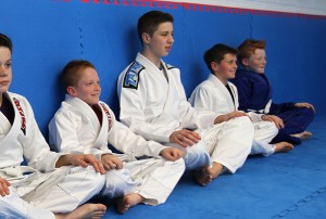 Lining up for the start of a kids BJJ class